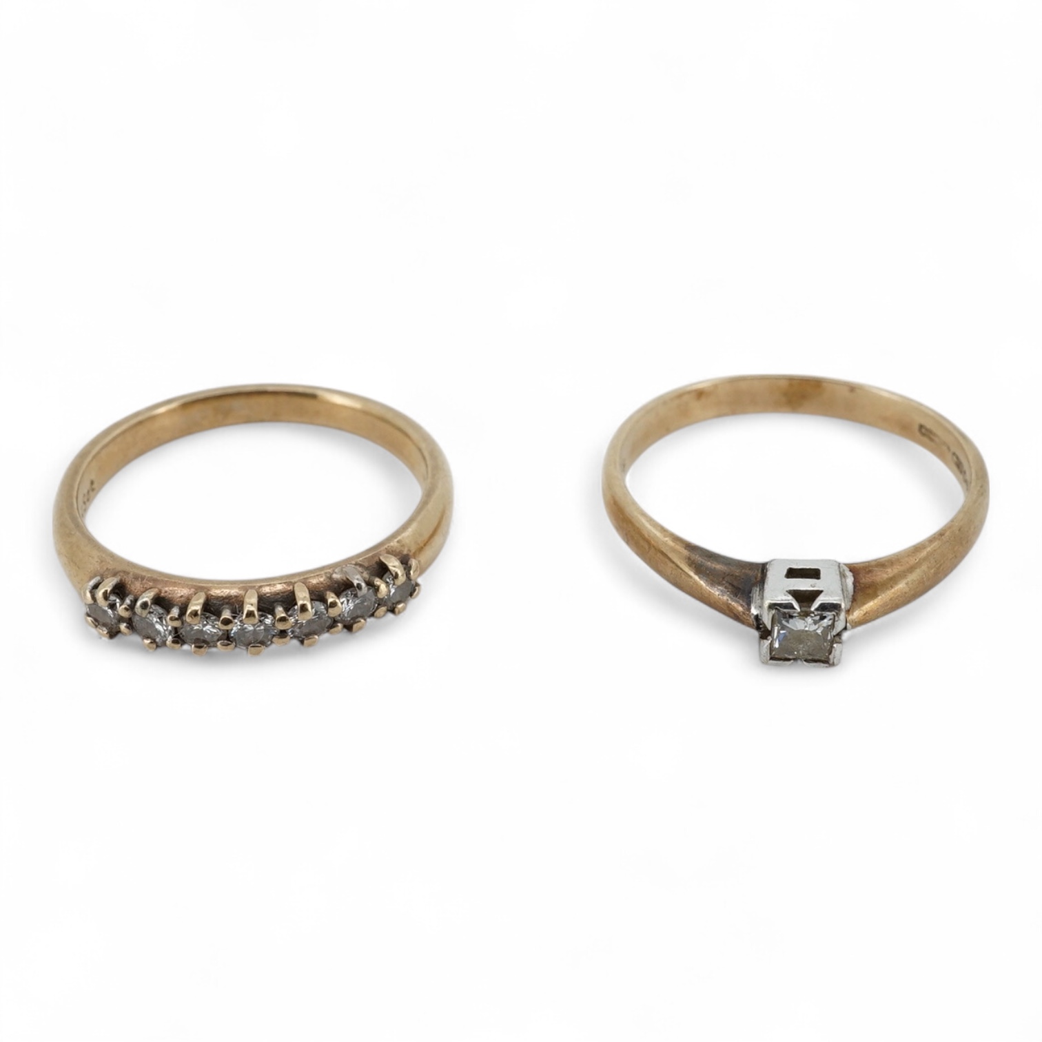 A 9ct gold and solitaire diamond set ring, size O/P and a 9ct gold an seven stone diamond set half hoop ring, size O, gross weight 4 grams.